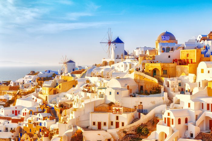 Skyline of Oia, traditional white architecture with windmills, greek village of Santorini, Greece. Santorini is island in Aegean sea, famous summer resort.