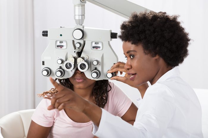 Female African Optometrist Doing Sight Testing For Patient In Hospital