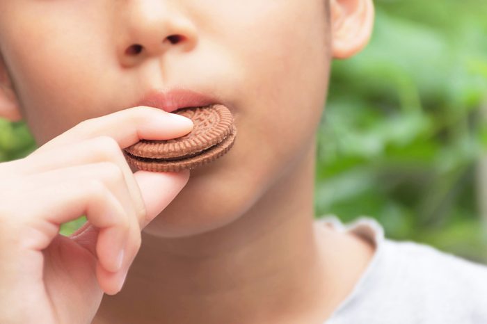 This kid is eating delicious cookies.