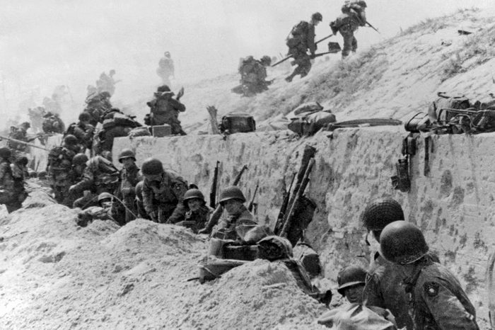 Normandy, France: June 9, 1944. American troops of the 4th Infantry Division at Utah Beach taking a breather before continuing the assault over the hill to the interior of France.