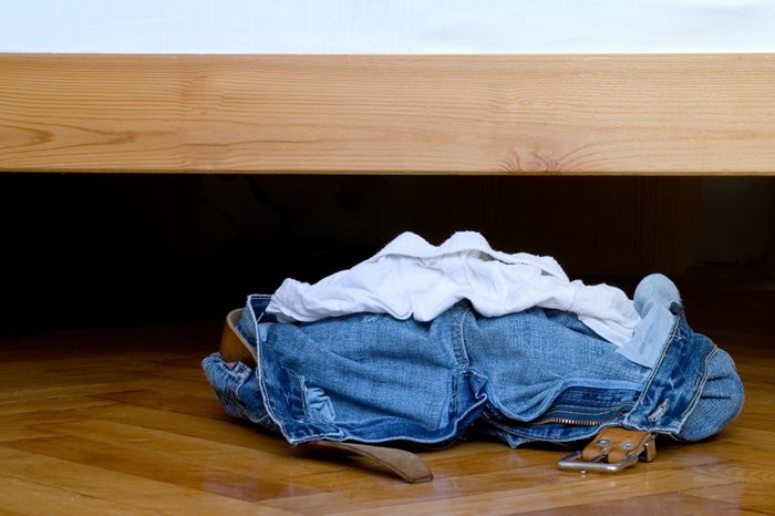 A pile of clothes laying on the floor.