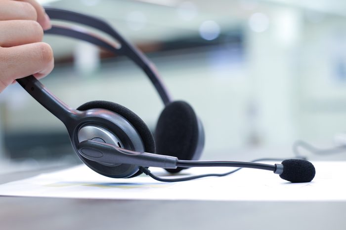 close up headset of call centre hotline at computer office room