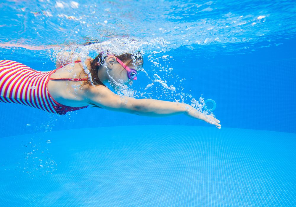 little girl swimming in pool