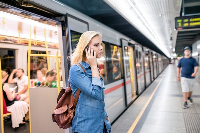 Woman making phone call at the underground platform