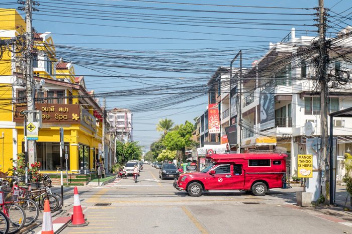 CHIANG MAI, THAILAND - FEBRUARY 3: Iconic traditional red truck taxi roames the streets on February 3, 2016 in Chiang Mai. Chiang Mai is a major tourist destination in northern Thailand