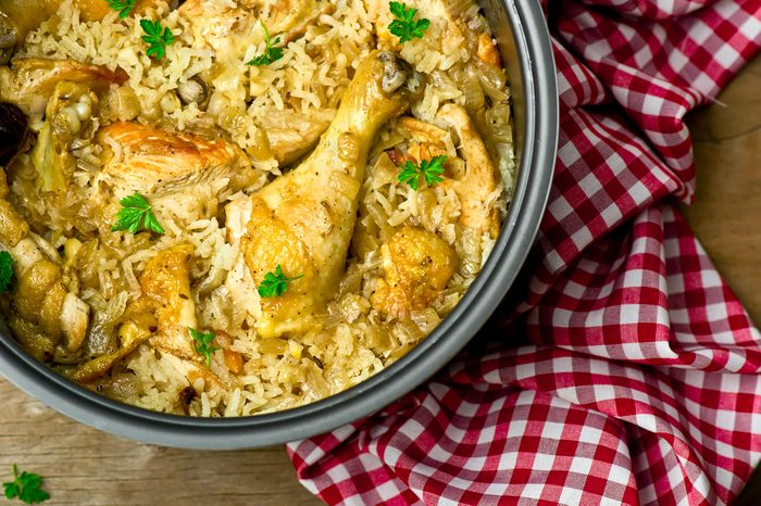 Stewed chicken with rice and dates in the crock-pot.selective focus