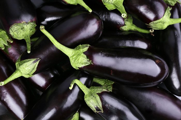 Heap of fresh eggplants close up