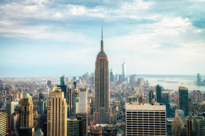 NEW YORK CITY - JULY 16,2016: Observers view Midtown from Top of the Rock Rockefeller center. Manhattan is often described as the cultural and financial capital of the world. Splittoned image.