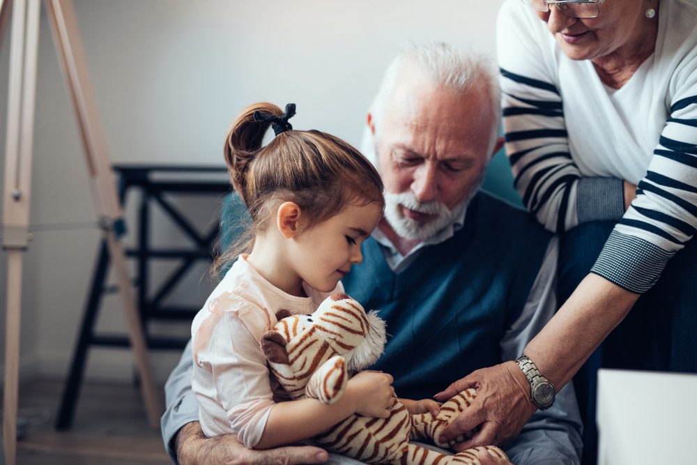 Grandparents playing with their granddaughter