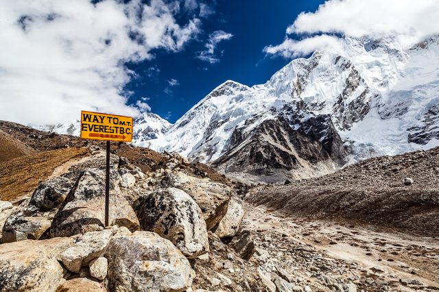 Footpath to Mount Everest Base Camp signpost in Himalayas, Nepal. Khumbu glacier and valley snow on mountain peaks, beautiful view landscape