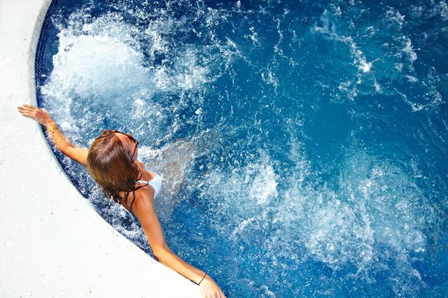 Beautiful girl relaxing in jacuzzi. Summer vacation