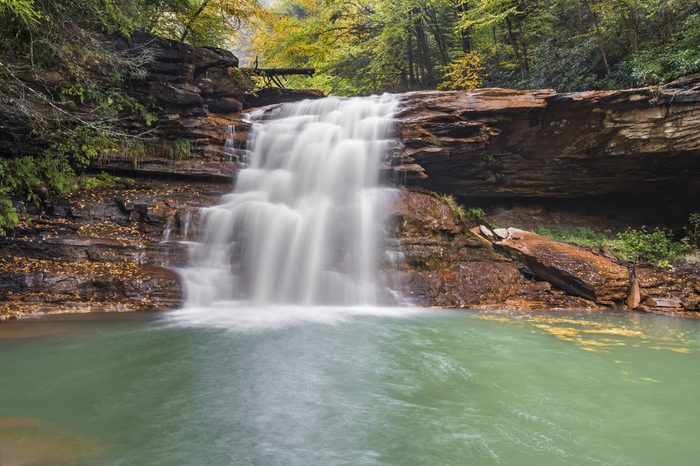 Kennedy Falls, a remote waterfall on the North Branch of West Virginia's Blackwater River, tumbles over mineral-stained rocks on a rainy autumn day.