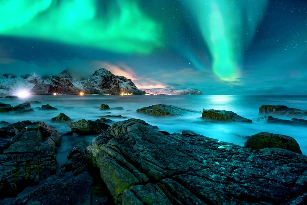 Aurora borealis above snowy islands of Lofoten