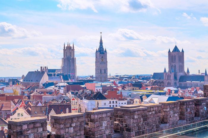 Aerial panoramic view of Ghent, Belgium with roofs and traditional medieval buildings, church tower