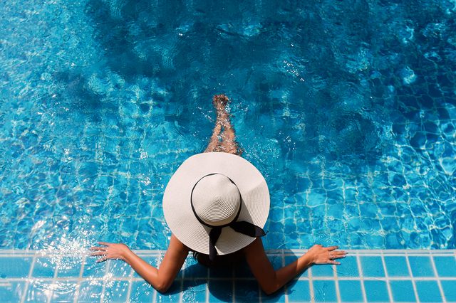 Young asian woman relaxing in swimming pool at spa resort.relaxing concept.