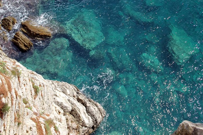 Cliff and rocky boulders on the bottom of the sea