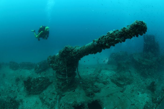 Shipwreck of the Torpedo boat Giuseppe Dezza and scuba diver underwater in the Mediterranean Sea 