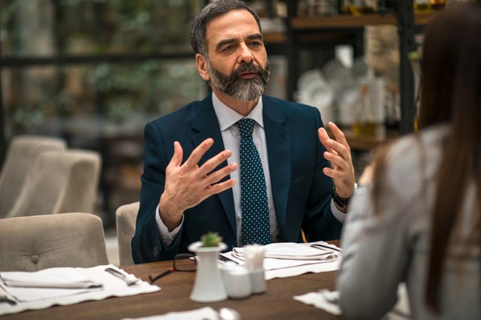 Business couple having conversation in restaurant.