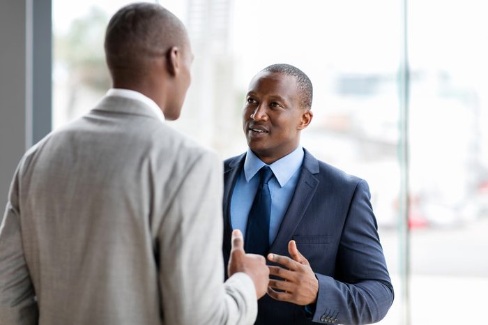 successful african american businessmen having conversation in office