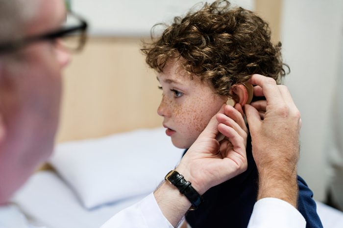 Young boy having his ears checked