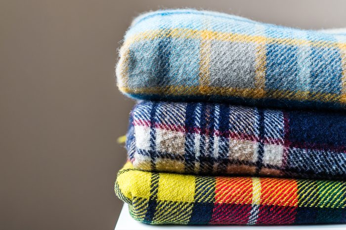 Stack of woolen checked blankets, autumn and winter concept