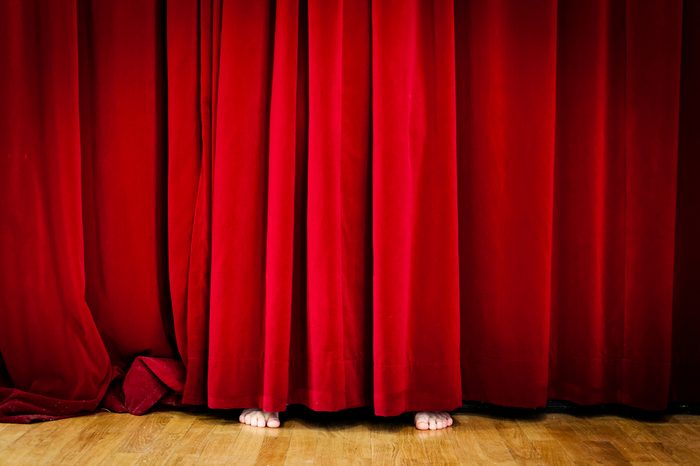 Hiding behind Red Curtain