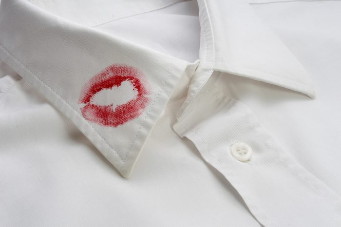 close up of white shirt and red lipstick on it