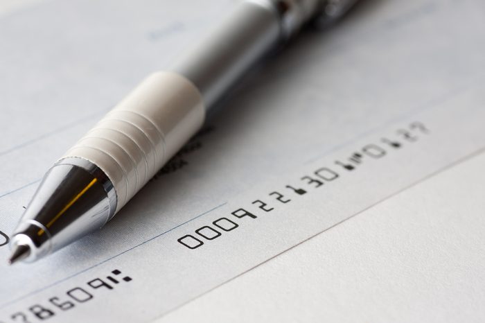 Close up shot of a cheque or cheque with a pen