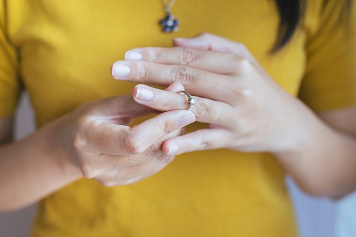 Woman push her silver wedding rings in finger