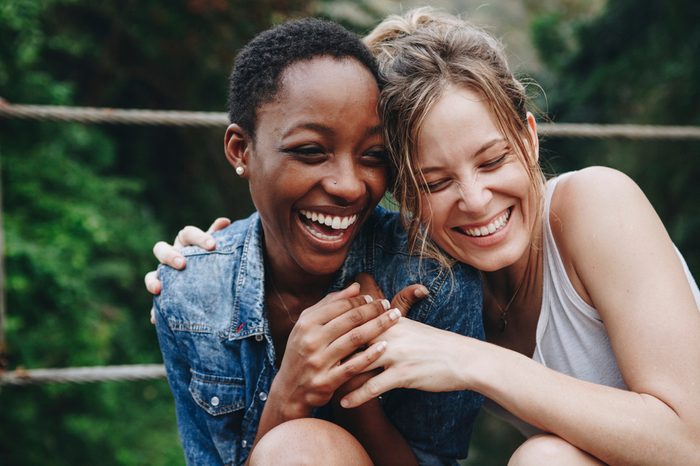 Happy friends holding each other