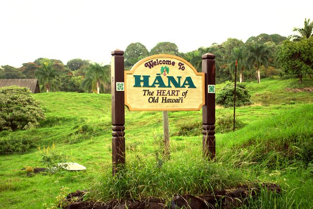 Sign welcoming visitors to the historic town of Hana following a winding scenic drive along Maui's coast.