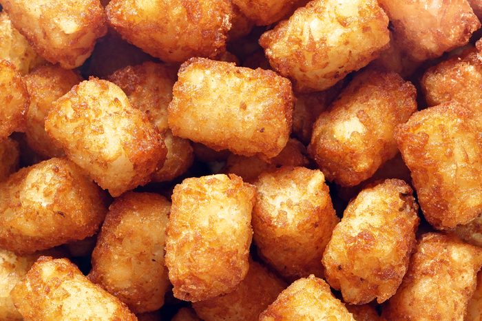 close up of rustic golden potato tater tots food background