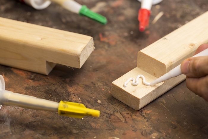 putting glue on a piece of wood