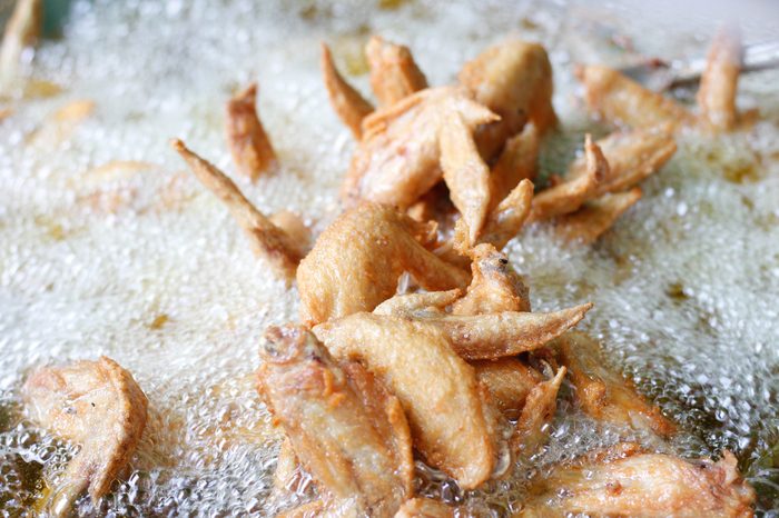 Fried chicken in hot oil and boiling in pan