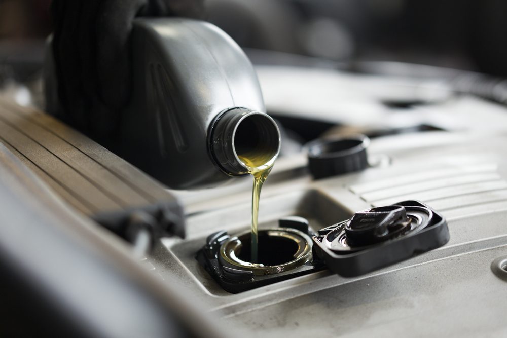 A technician in the workshop exchanges oil