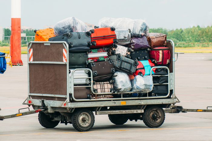 Airport luggage Trolley with suitcases before loading into the aircraft