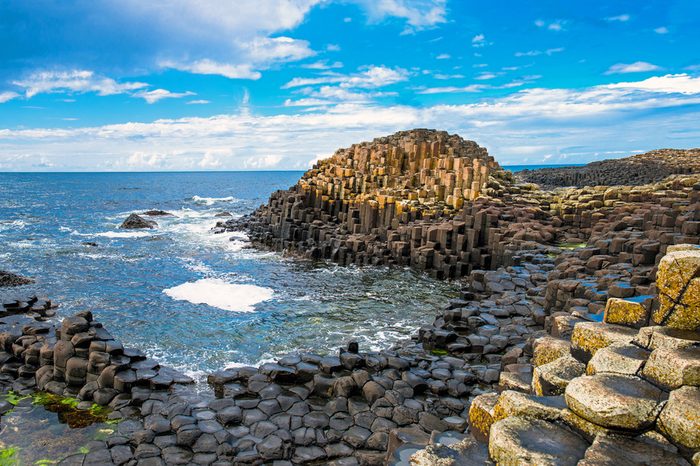 Landscape of Giant's Causeway trail with a blue sky in summer in Northern Ireland in United Kingdom. UNESCO heritage.