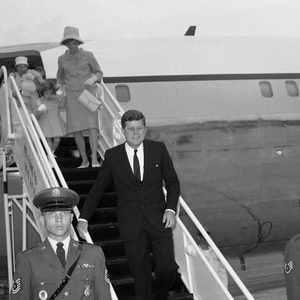 John Kennedy, JFK, Jacqueline Kennedy President John F. Kennedy leaves his plane at Otis Air Force Base, Mass.,, for a long weekend holiday at his nearby Hyannis Port home. Mrs. Jacqueline Kennedy walks down the ramp hand-in-hand with daughter Caroline. Nurse Maud Shaw carries John Jr., in the background