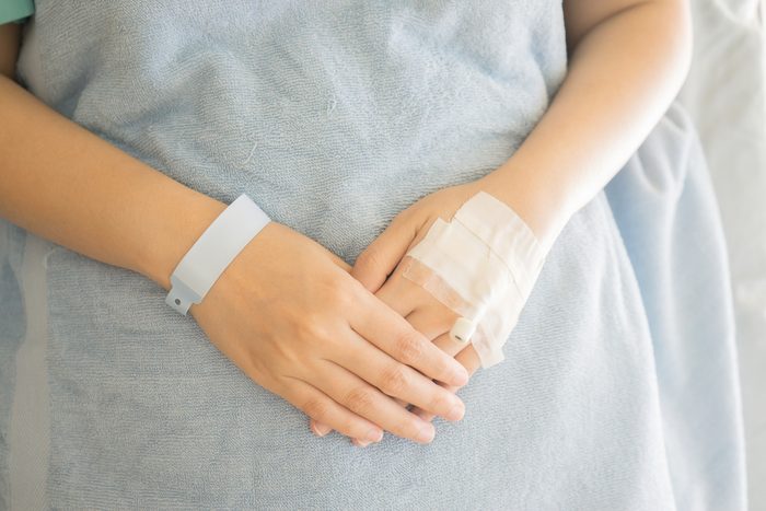 Patient ID Bracelet ,hospital wrist tag,injection in hand,selective focus,vintage color,copy space