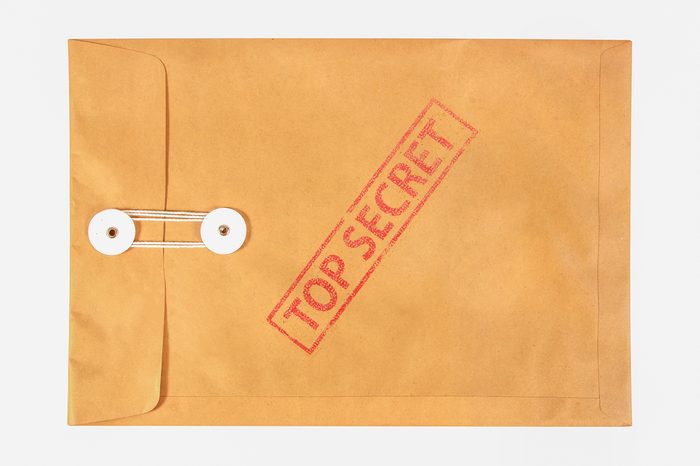 Stamp top secret on the brown envelop file ,isolated on white background