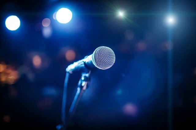 Microphone on stage against a background of auditorium