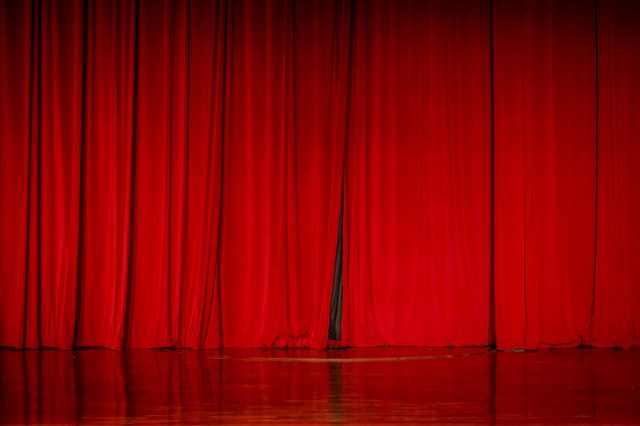 Red curtains in a theater scene of the show.