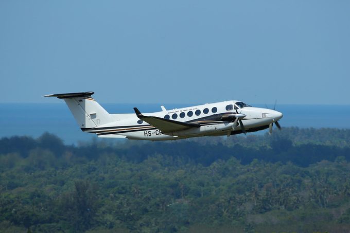 Phuket, Thailand. December 25, 2016. Siam Land Flying CO., Ltd Beechcraft King Air 350iER Reg. HS-CPA Taking Off from Phuket International Airport with Landscape and Seascape Background.