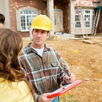 Construction: New Home Construction Site with Builder.