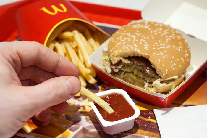 Minsk, Belarus, January 8, 2018: Man is eating at McDonald's restaurant.