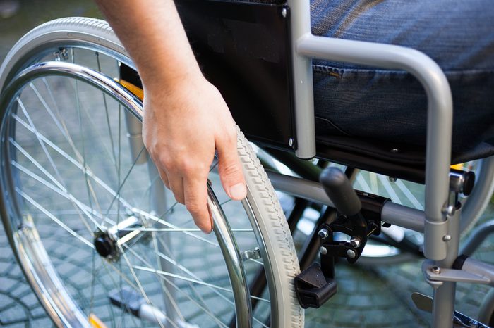 Paralyzed man using his wheelchair