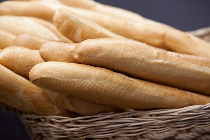 several baguettes wheat bread in wicker basket