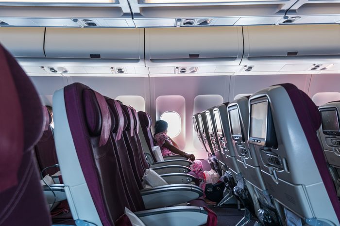 Beirut, Lebanon, May 2nd, 2017, An Indian woman looking at the window of airplane of Qatar Airways in the blue sky flying to Doha