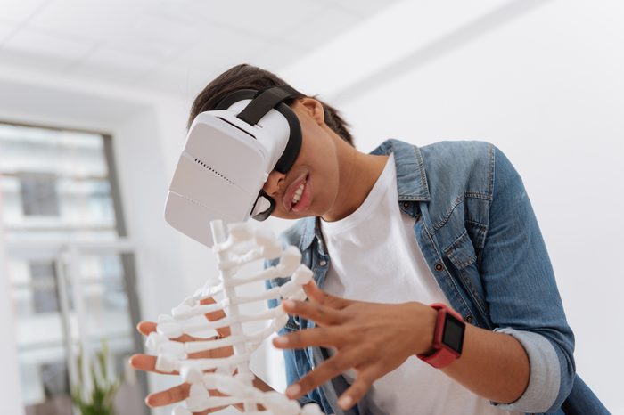 Joyful curious woman using 3d technology