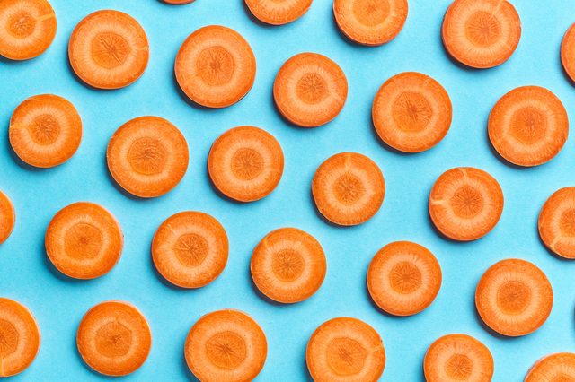 sliced carrot on blue color background